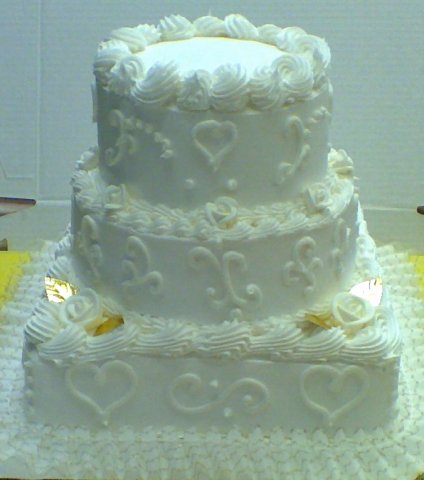3 tier gold leaves - 3 tiers round and square with white trim, gold foil leaves and gold lace ribbon around the base.7&quot;, 9&quot;, 12&quot; tiers, 15 pounds. Serves 75 to 90.